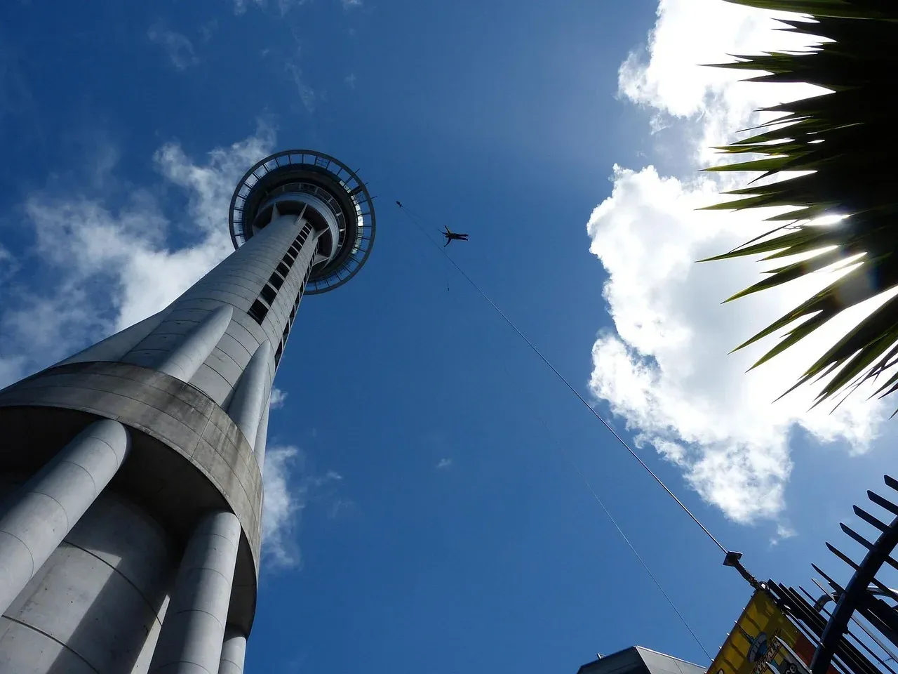 The Sky Tower in Auckland seen from its base against a blue sky