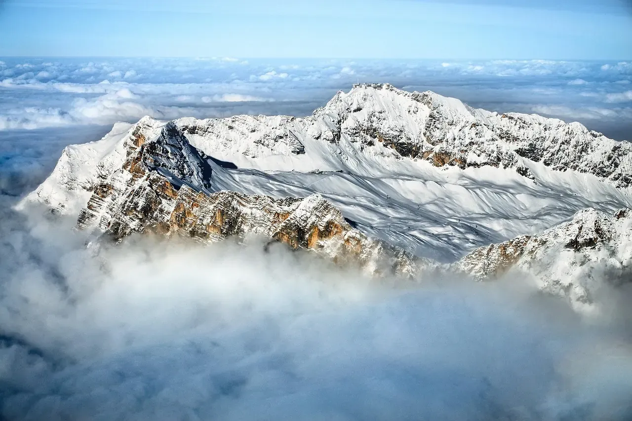 The snow covered ridge of the Zugspitze rising above a sea of cloud in Bavaria