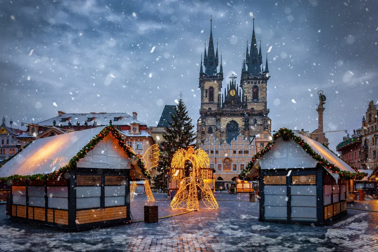 Snow-covered market huts in front of the Týn Church on Old Town Square, Prague