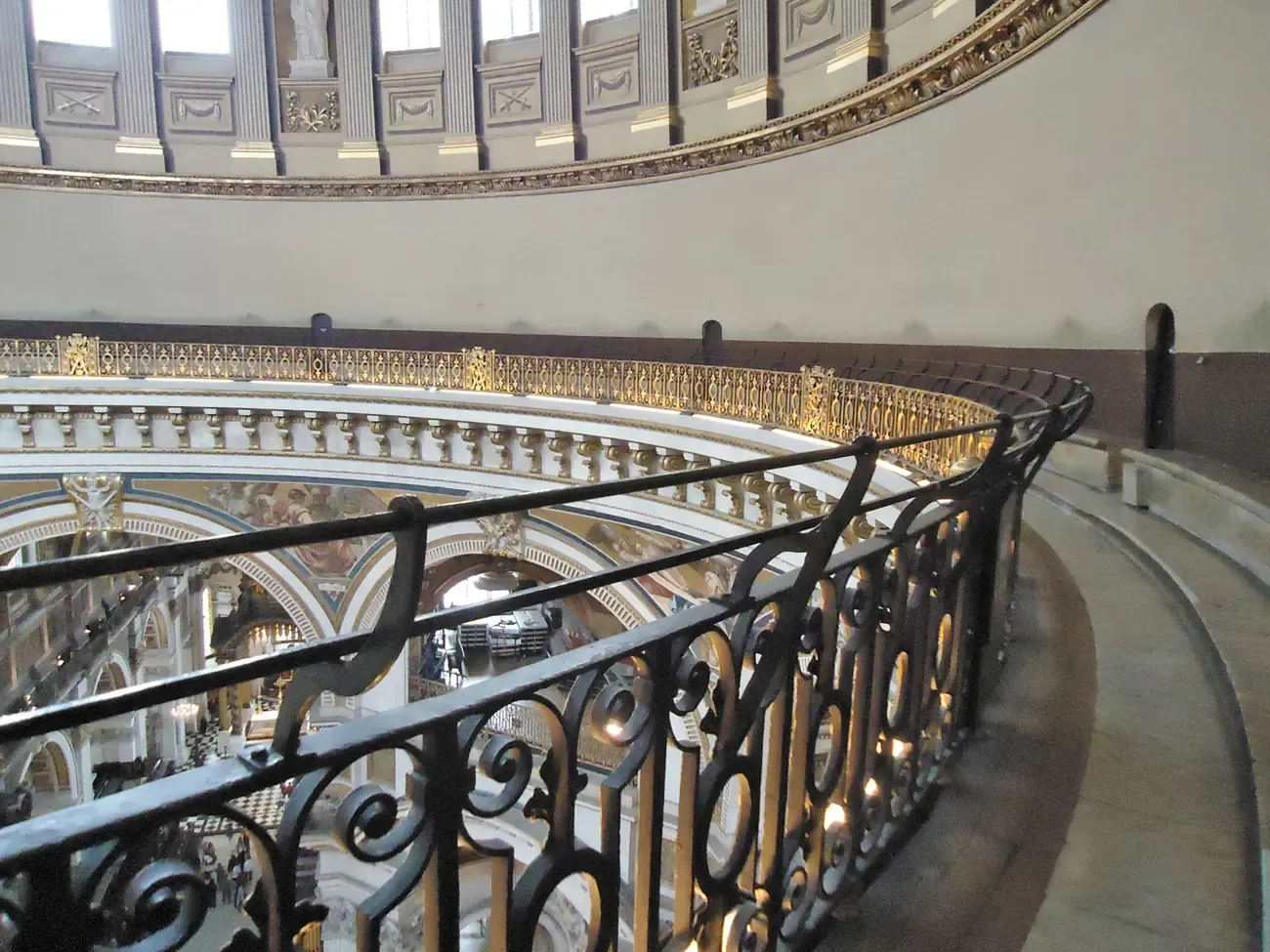 The curved Whispering Gallery with its wrought iron railing high inside the dome of St Paul's Cathedral in London
