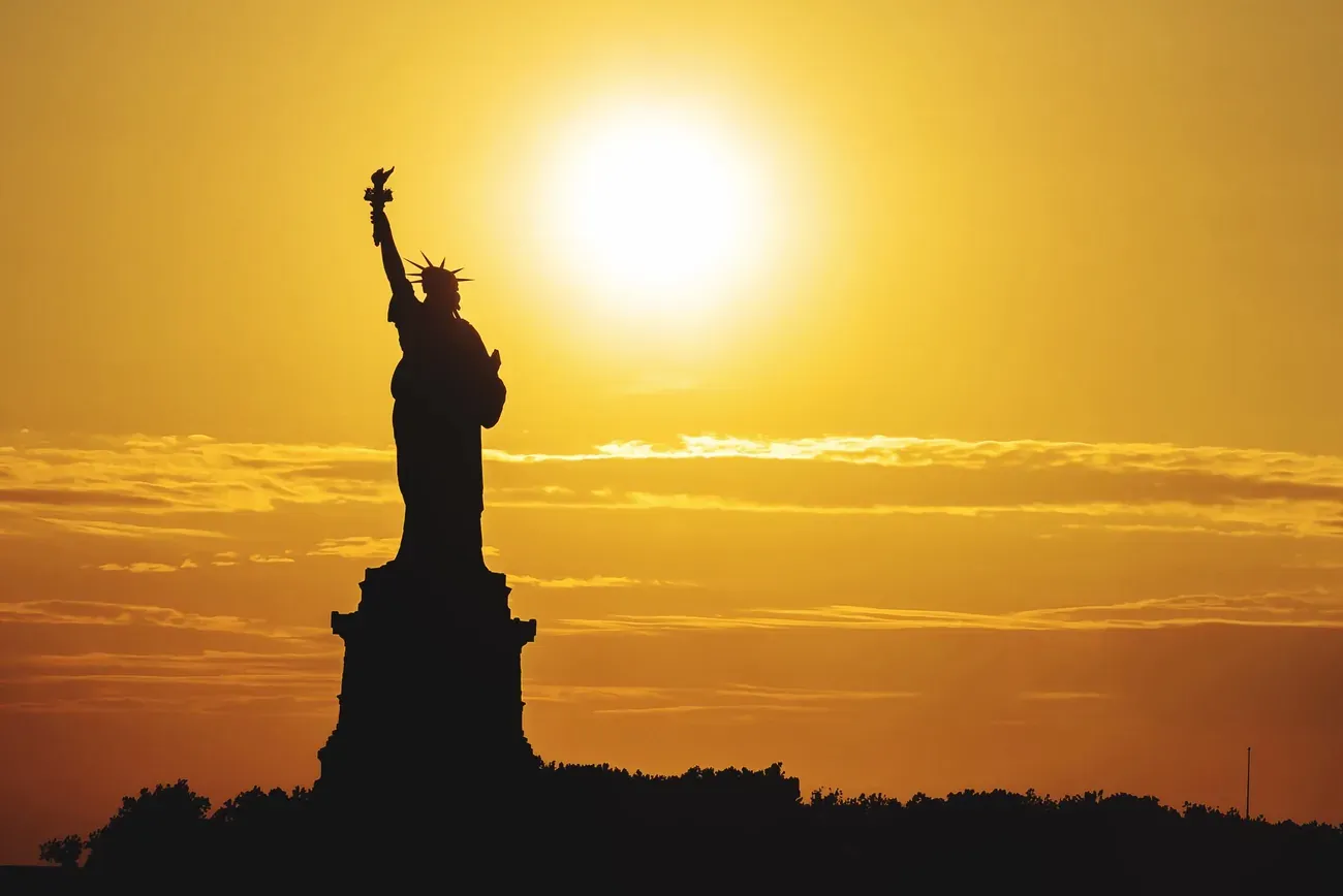 Silhouette of the Statue of Liberty at sunset, New York
