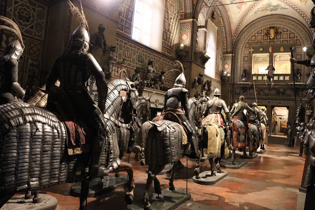 Mounted knights in armour lined up in the Sala della Cavalcata of the Stibbert Museum in Florence