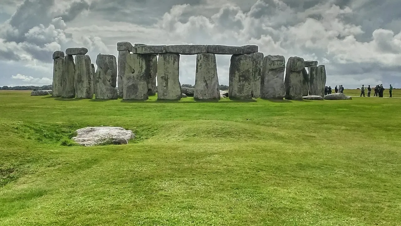 The standing stones of Stonehenge seen across the grass of the plain