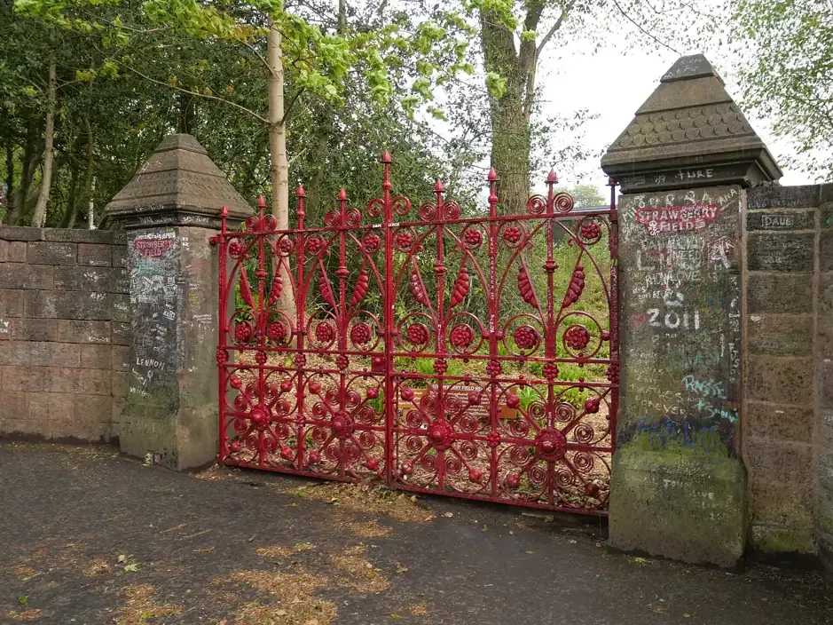 The red Strawberry Field gates beside the fan graffiti on the boundary wall, Liverpool