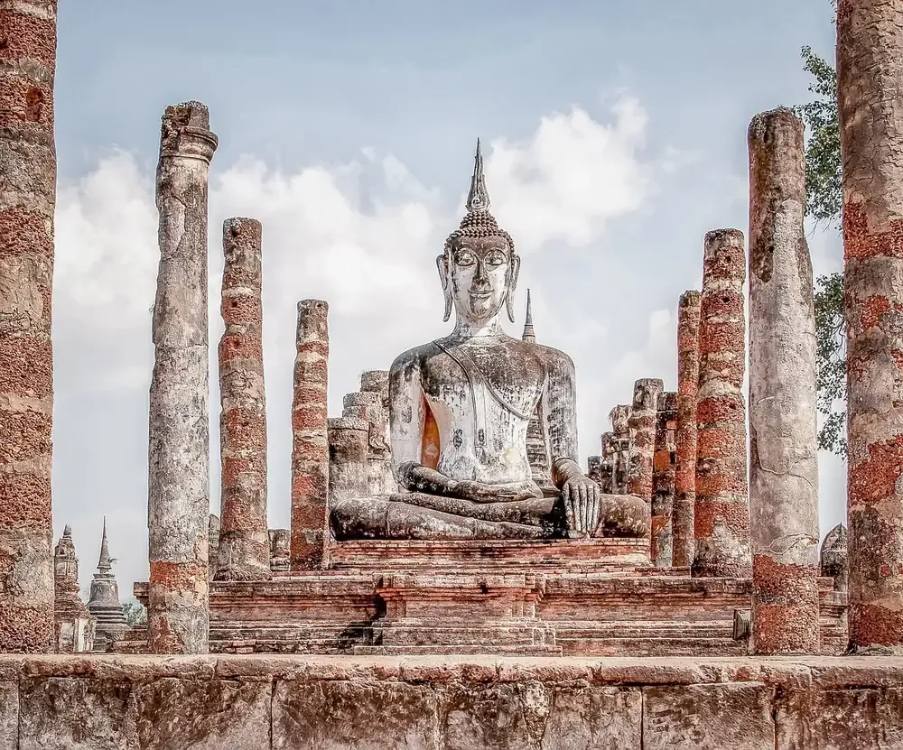 The seated Buddha among brick columns at Wat Mahathat in Sukhothai