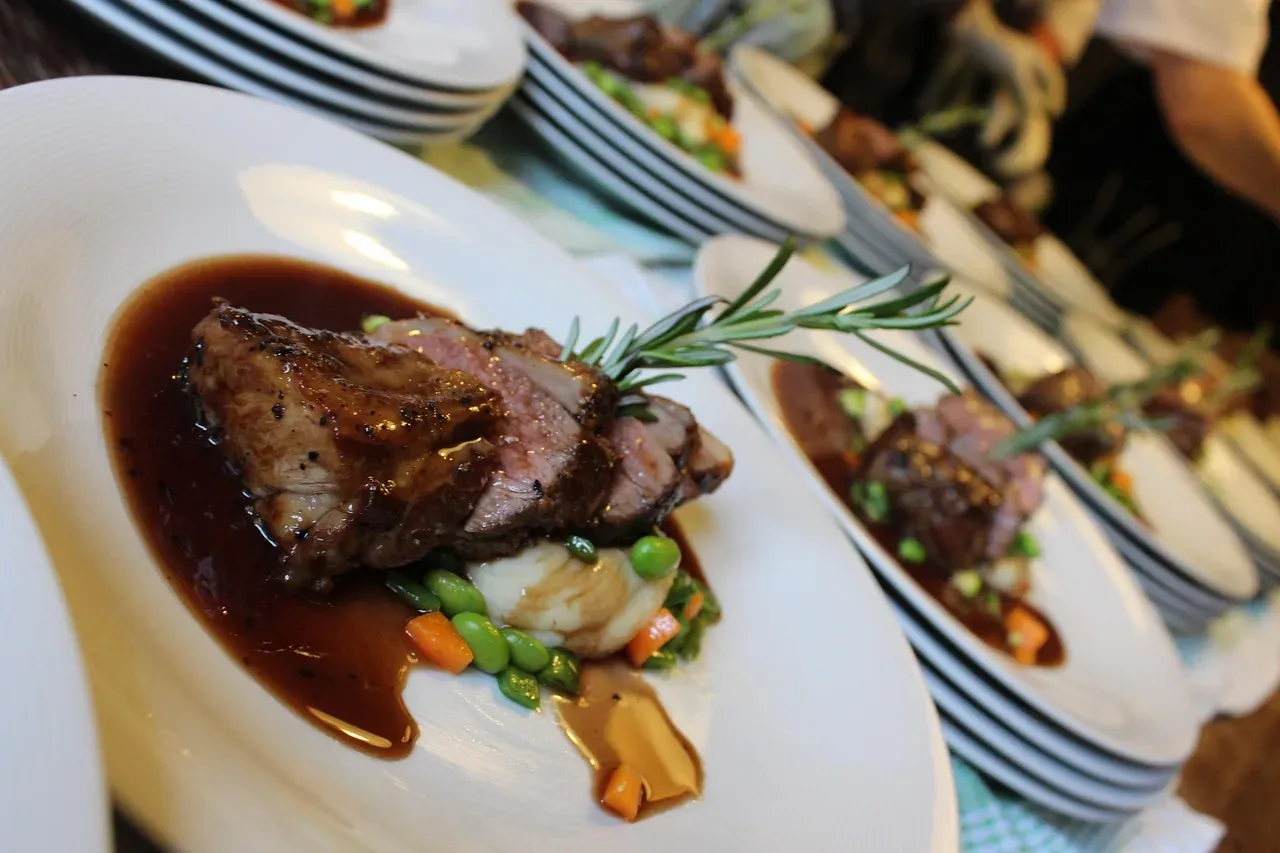 A plated Sunday roast of lamb with gravy and seasonal vegetables