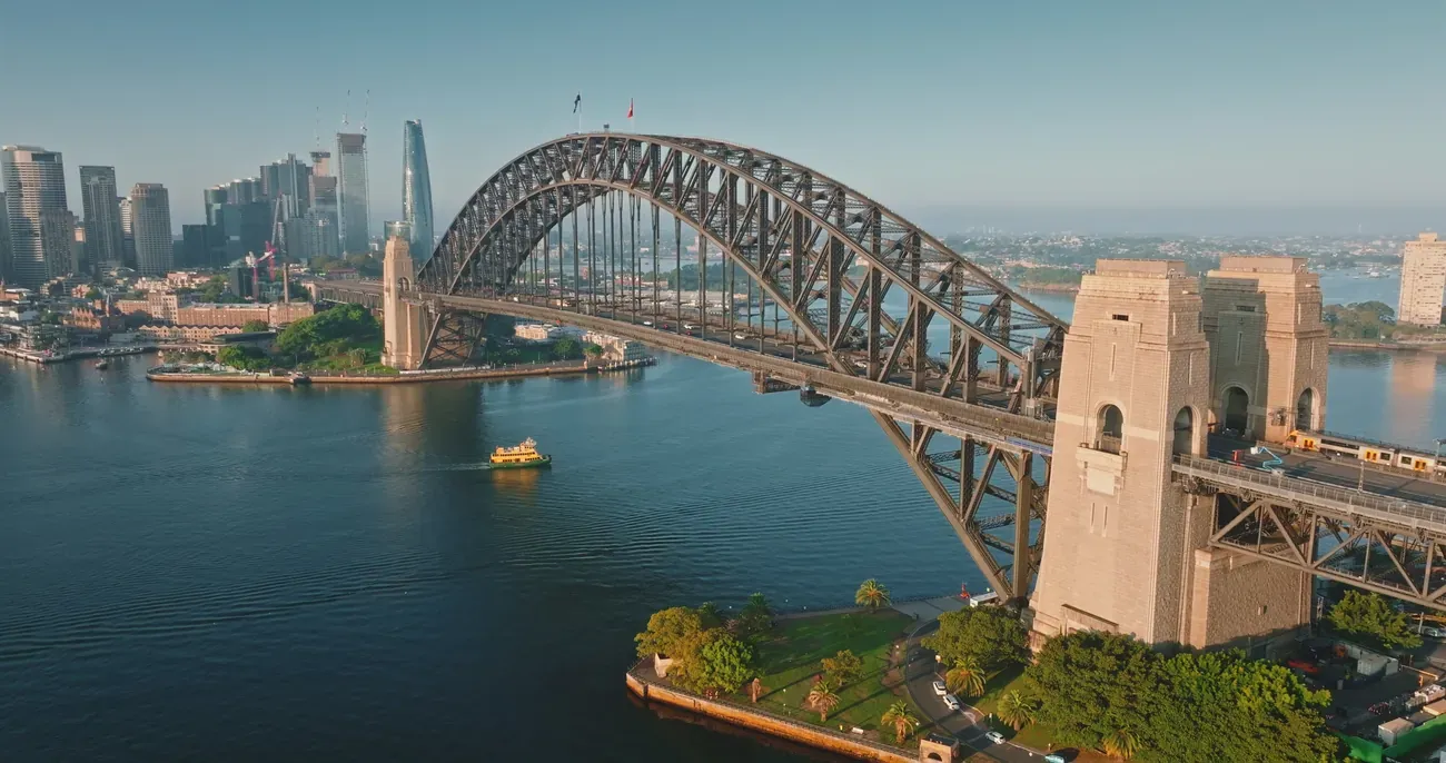 An aerial view of the Sydney Harbour Bridge in morning light