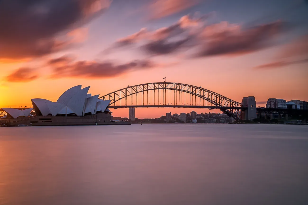 The Sydney Harbour Bridge against a pink and blue sky at sunset
