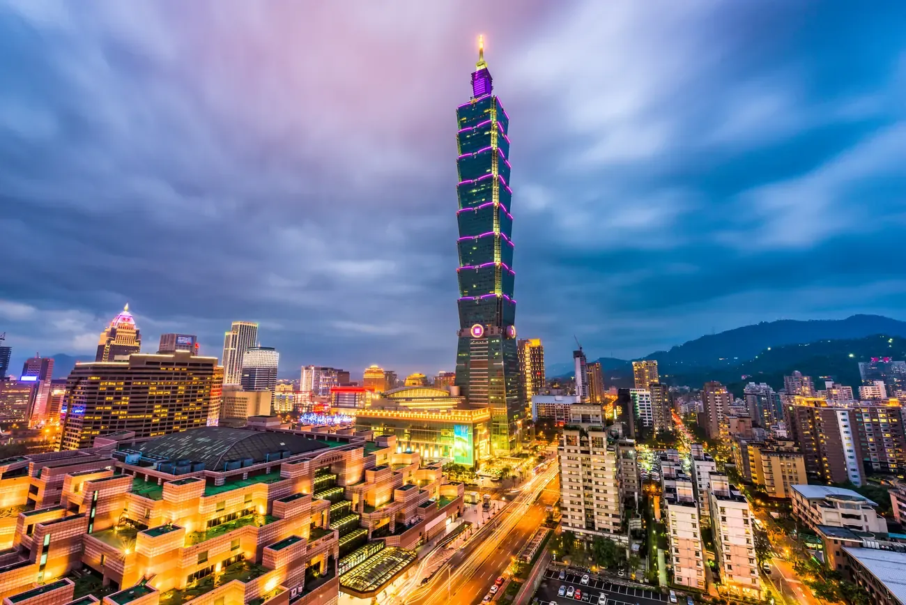 Taipei 101 rising above the city skyline at dusk