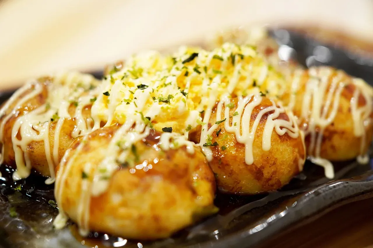Takoyaki octopus balls brushed with sauce and mayonnaise