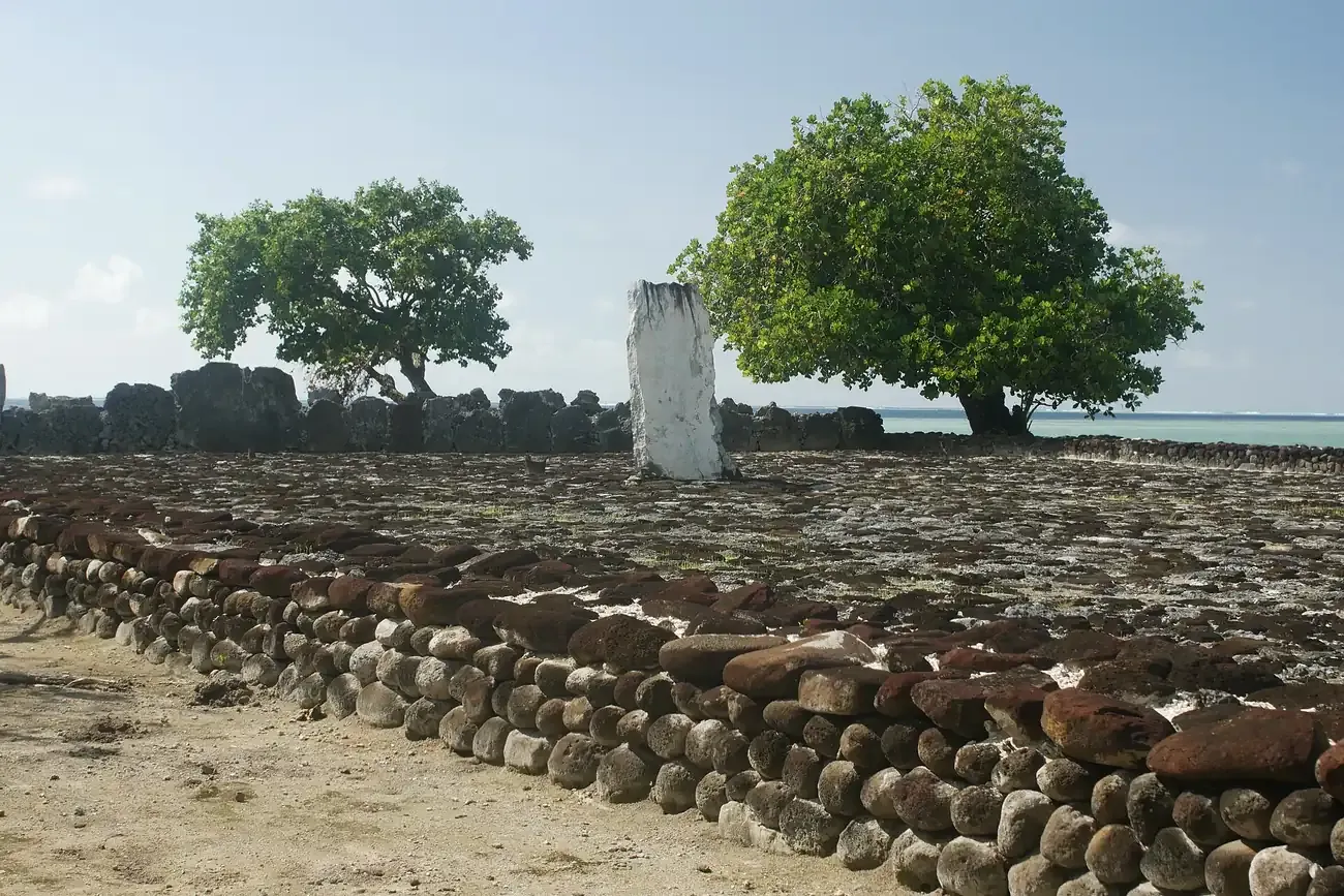 The paved courtyard and standing stone of the Taputapuātea marae beside the lagoon on Raiatea
