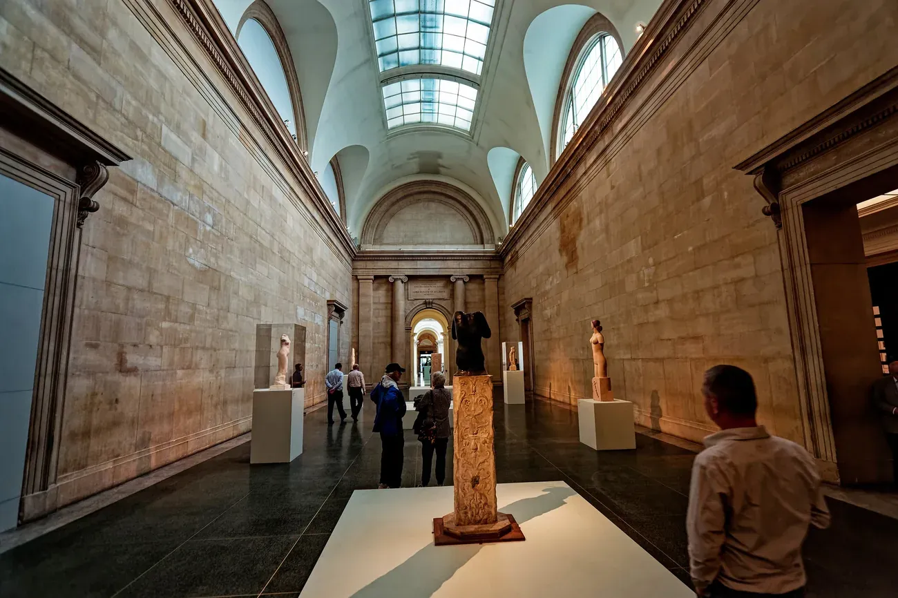 Visitors walking through the skylit Duveen Galleries at Tate Britain in London