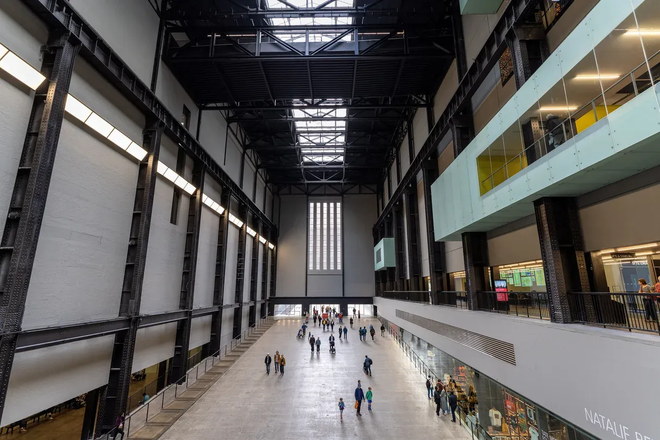 The Turbine Hall at Tate Modern seen from an upper level, with visitors on the floor below, London