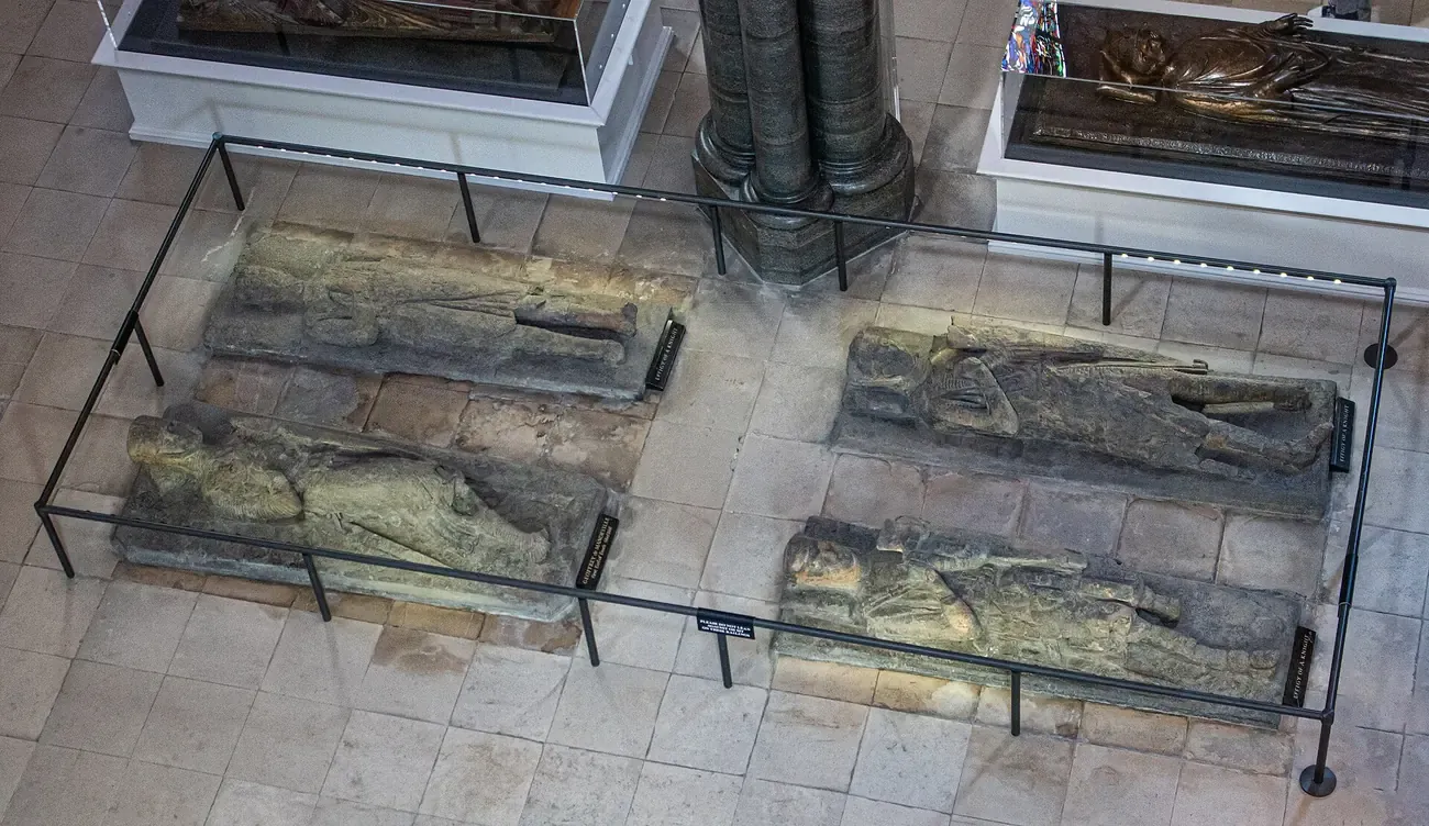 Carved stone effigies of medieval knights lying on the floor of the round nave of Temple Church in London