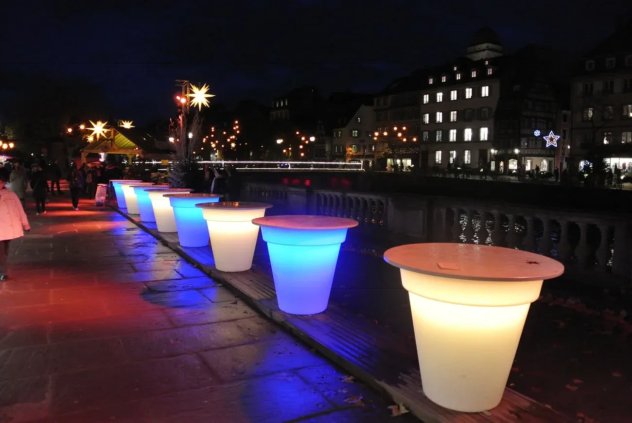 Lit tables on the terrace of the Palais Rohan by the Ill in Strasbourg at night