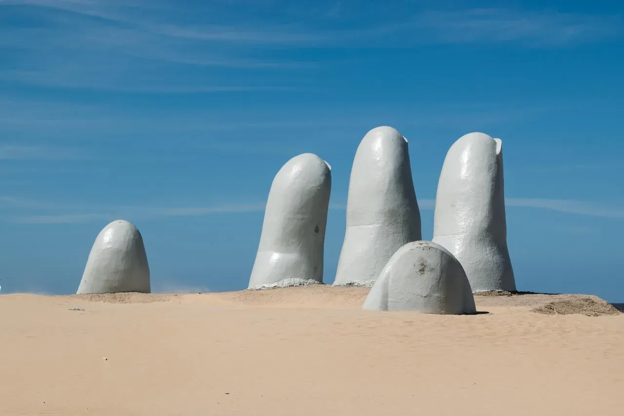 The fingers of the Hand sculpture rising from the sand of Brava Beach, Punta del Este