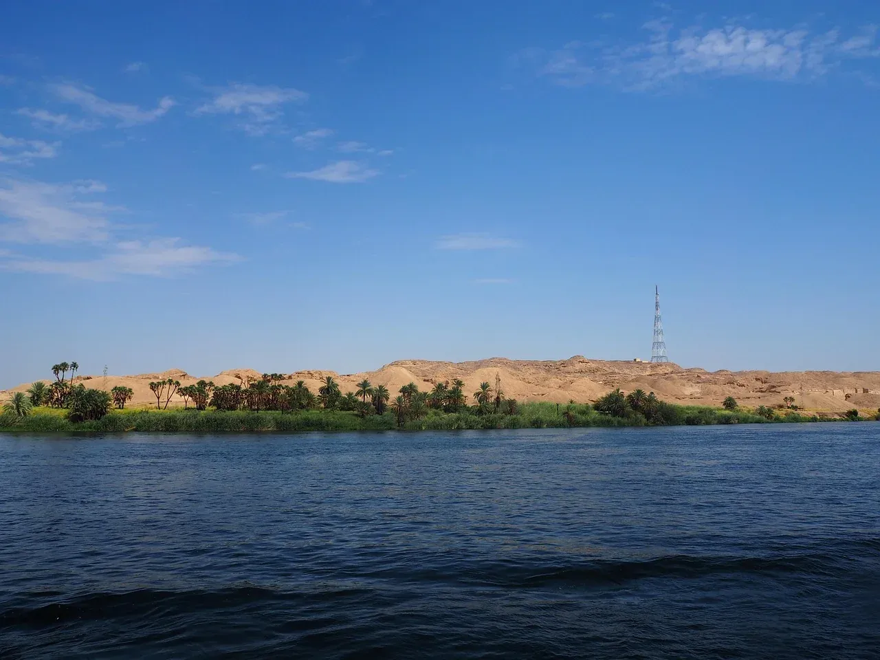 The Nile at Aswan with desert dunes on the far bank