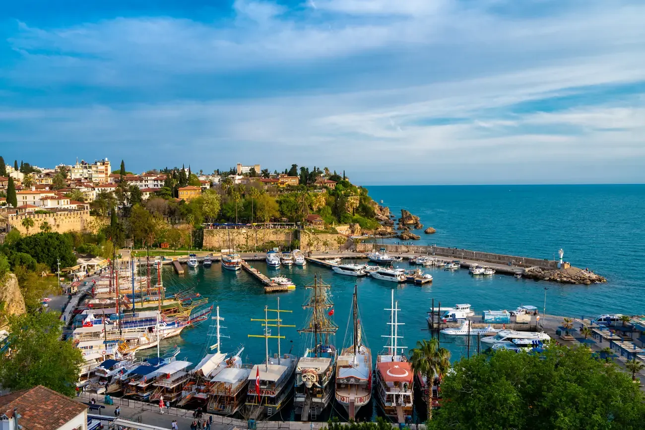 Panoramic view of Kaleici old town's historic walls above the marina in Antalya.