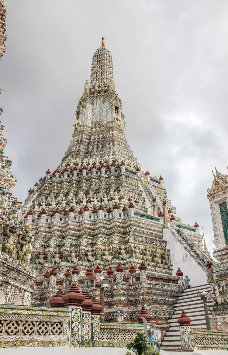 Close-up upward view of Wat Arun's central prang spire.