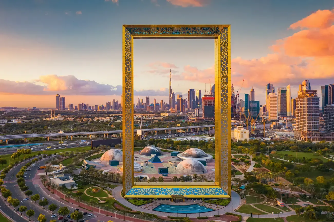 The Dubai Frame monument with the Burj Khalifa framed in the skyline behind it.