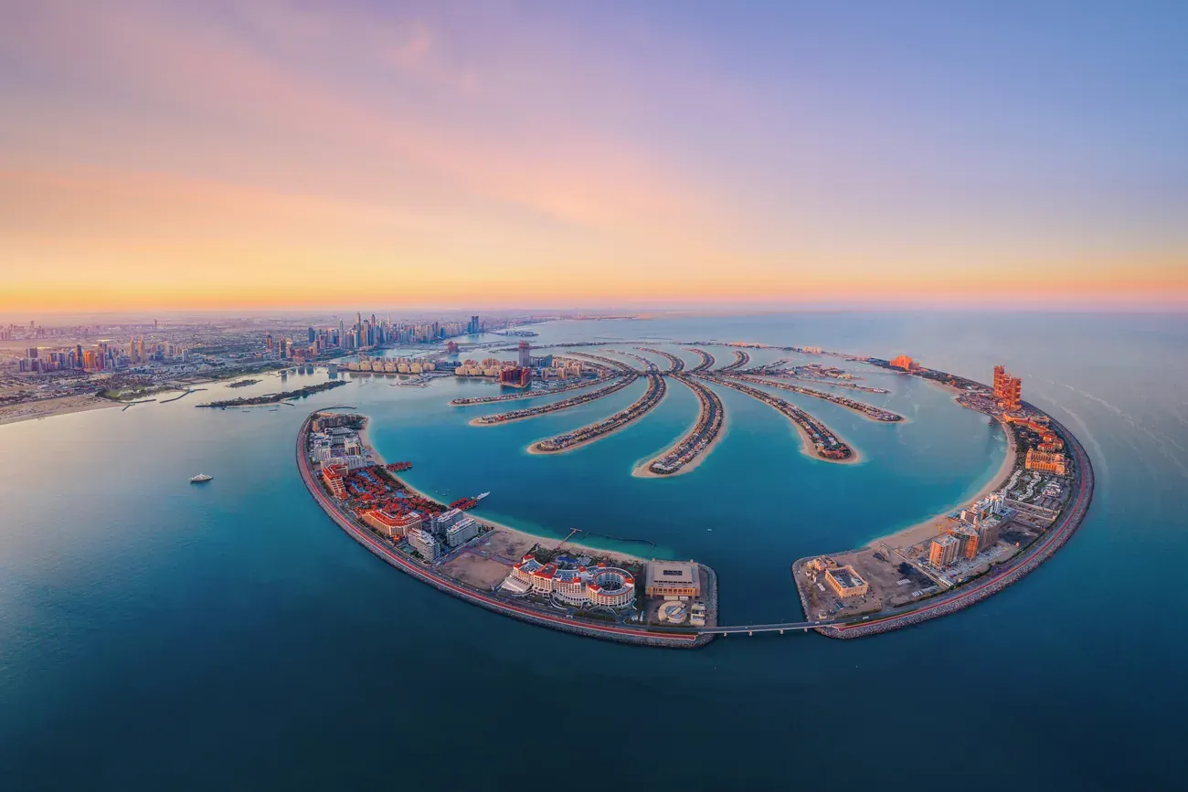 Aerial view of the Palm Jumeirah artificial island at sunset.