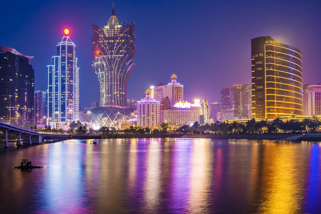 The Grand Lisboa tower illuminated at night in Macau.