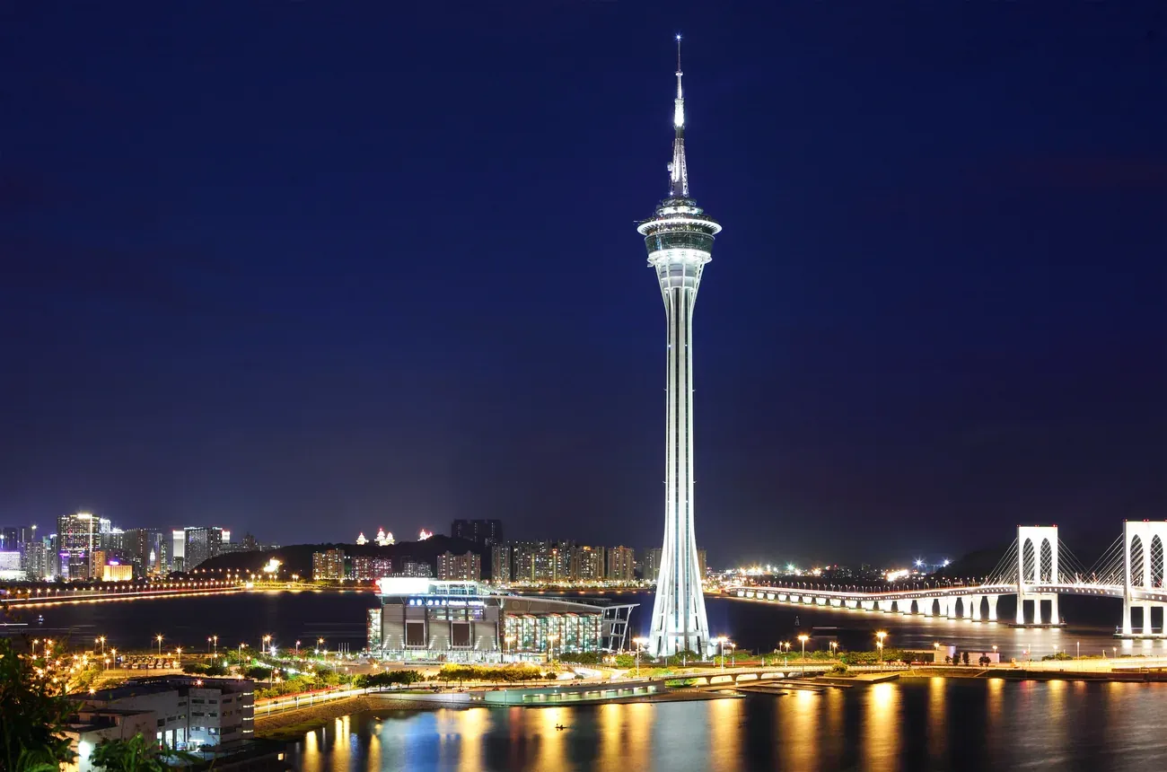 Macau Tower and the Sai Van Bridge lit up at night.