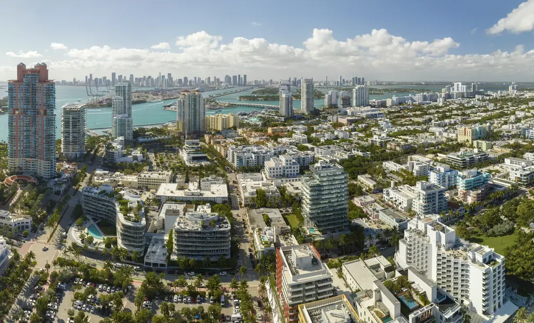 Aerial view over the low-rise blocks of Miami Beach towards the downtown Miami skyline
