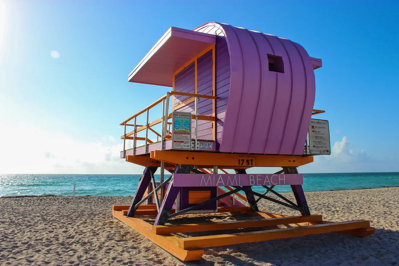 Purple and orange lifeguard tower on the sand at Miami Beach