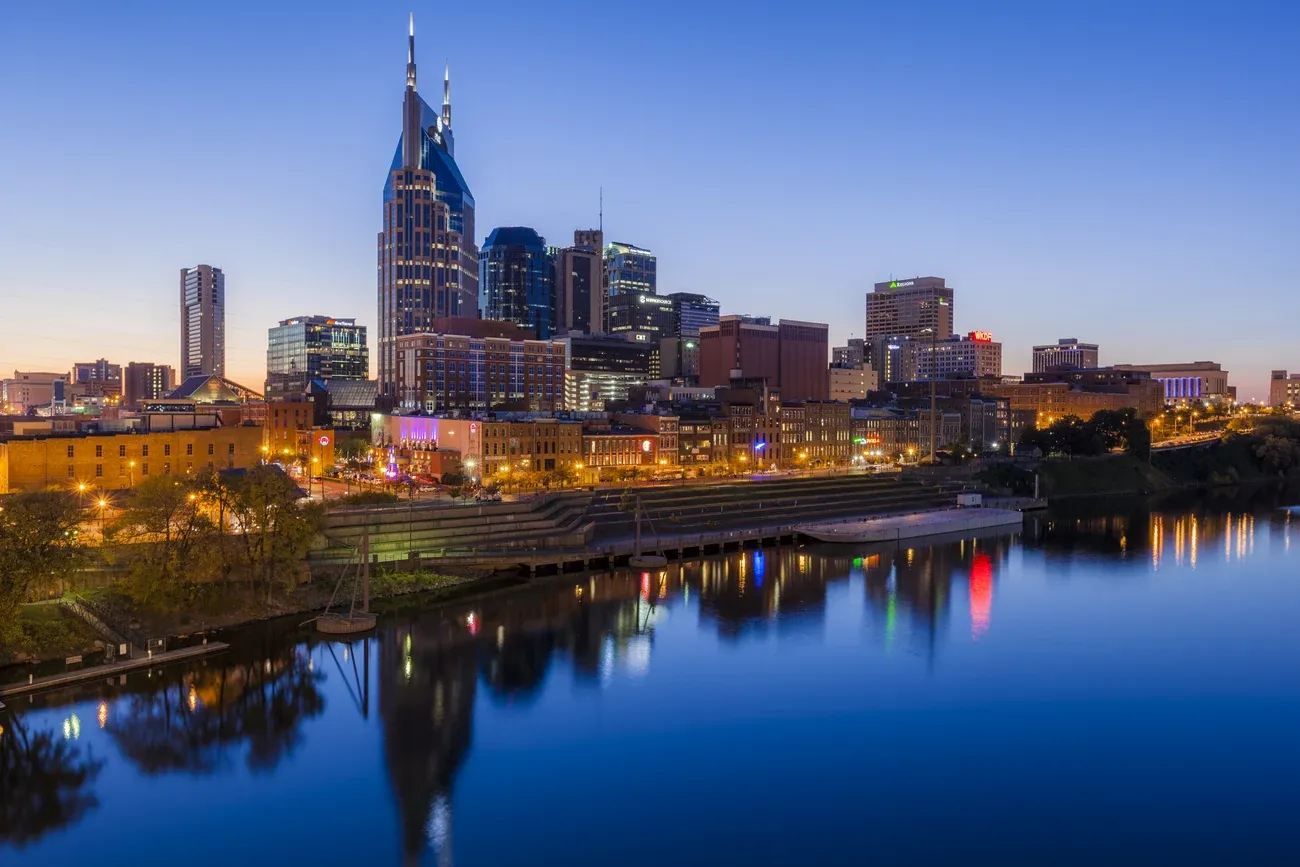 Nashville skyline above the still water of the Cumberland River at dusk
