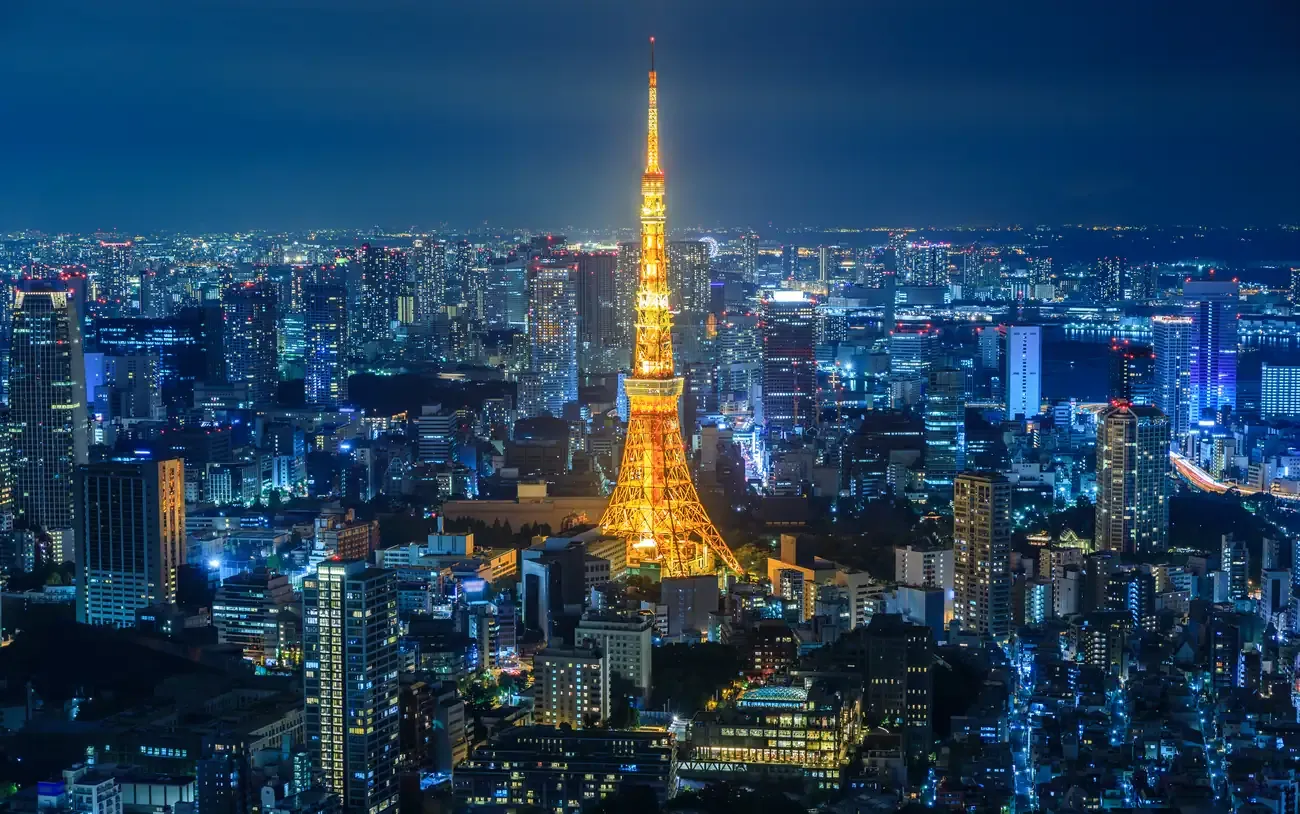 Tokyo Tower glowing orange above the city lights at night