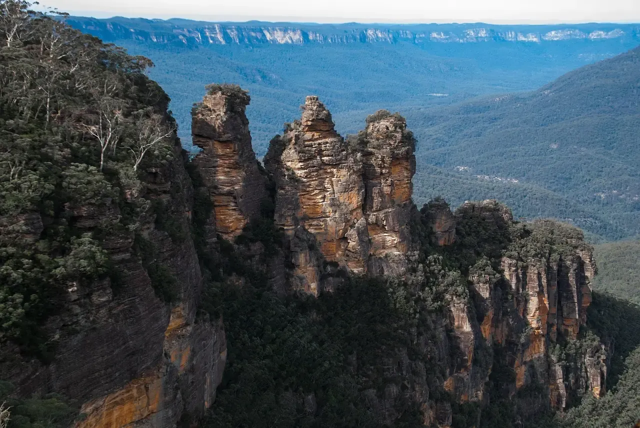 The Three Sisters standing above the forested Jamison Valley in the Blue Mountains