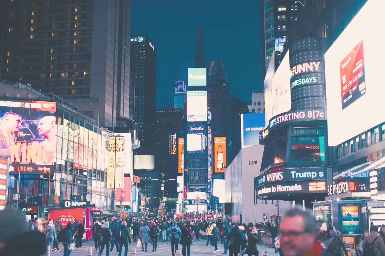 Illuminated billboards and crowds in Times Square at night, New York City