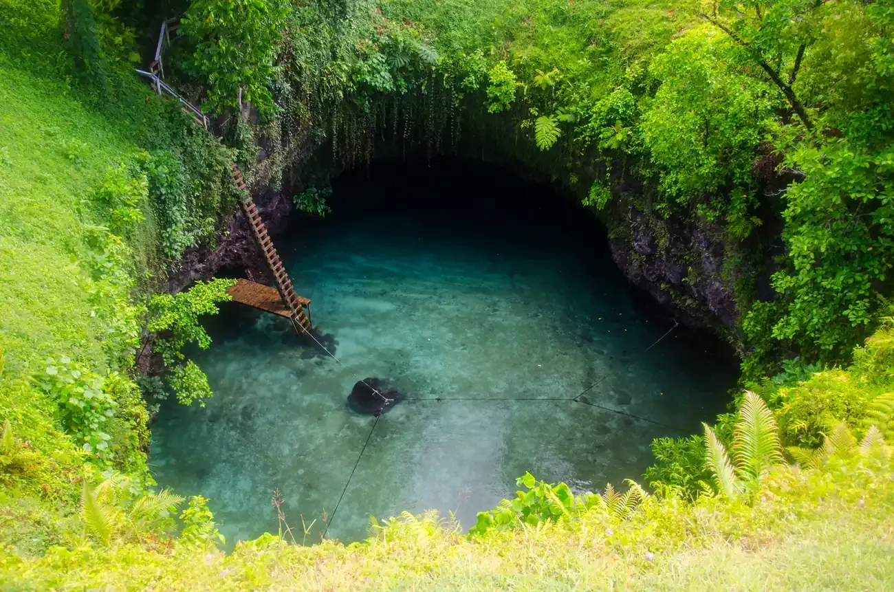 The To Sua Ocean Trench swimming hole and its ladder seen from above on Upolu, Samoa
