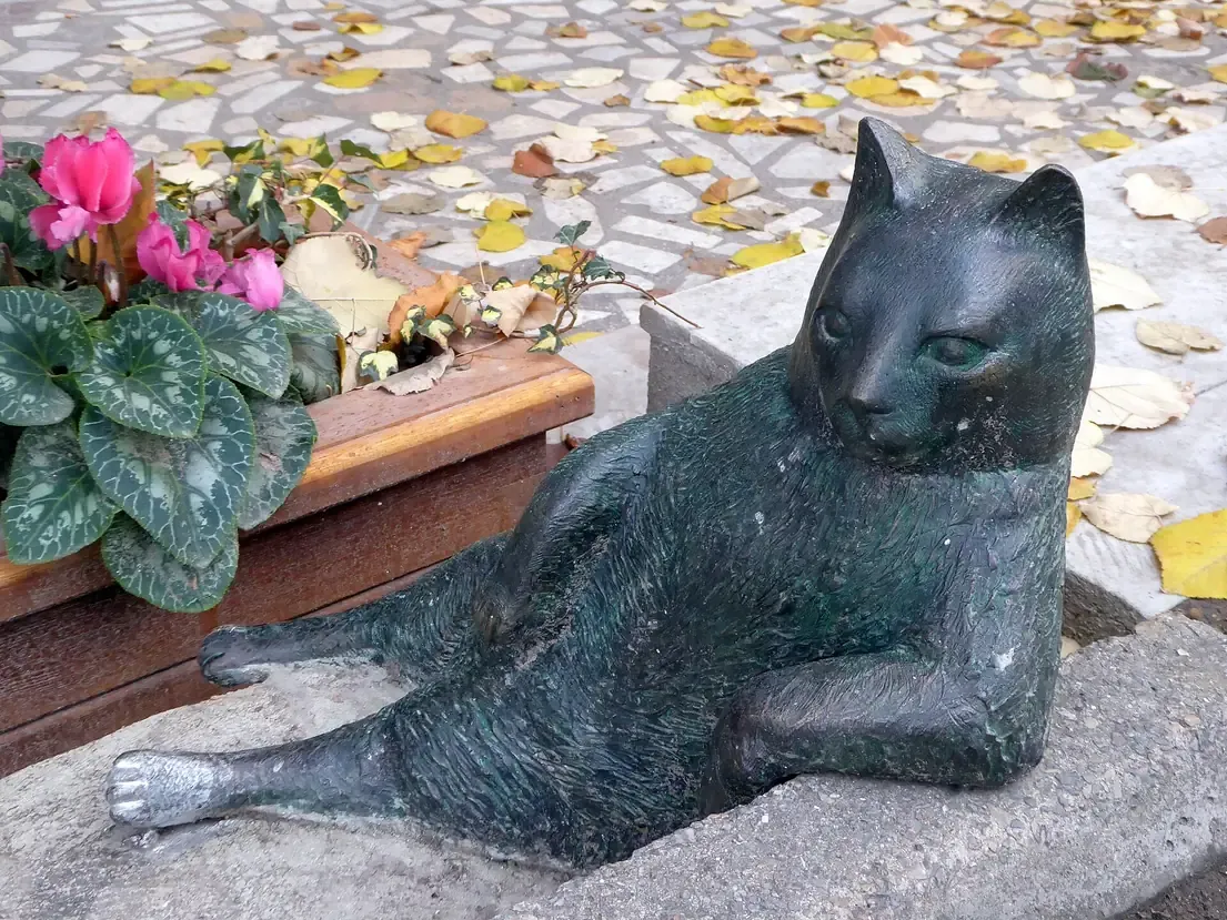 The bronze Tombili cat statue lounging on the pavement in Kadikoy, Istanbul