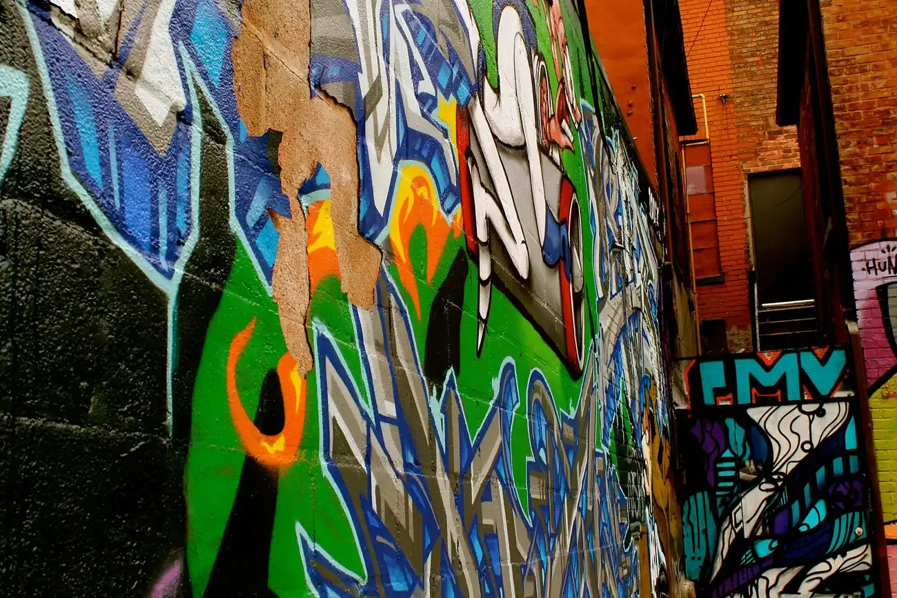 Murals covering the walls of Graffiti Alley behind Queen Street West in Toronto
