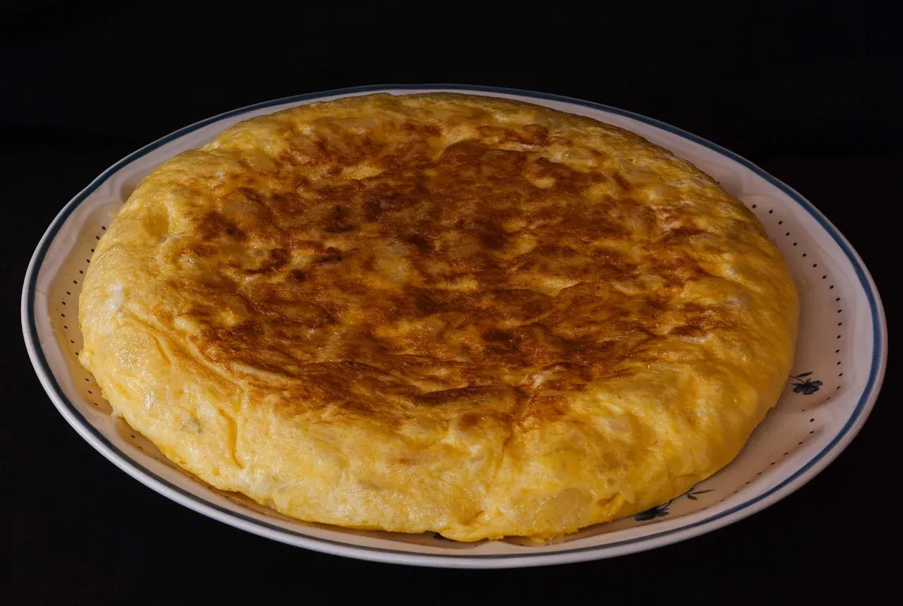 A whole Spanish potato omelette served on a plate