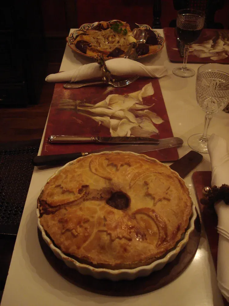 A tourtiere, the French Canadian meat pie, served at a laid table