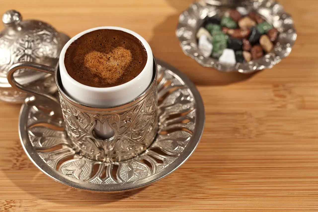 Turkish coffee served in an engraved metal cup holder