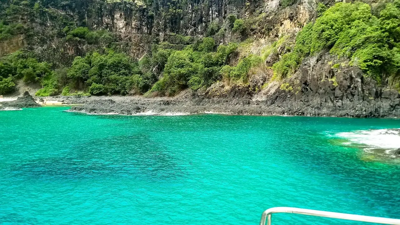 A turquoise cove under green cliffs at Fernando de Noronha