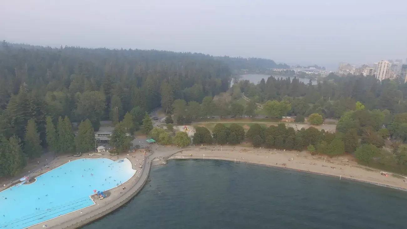 A panoramic aerial view of Stanley Park and downtown Vancouver