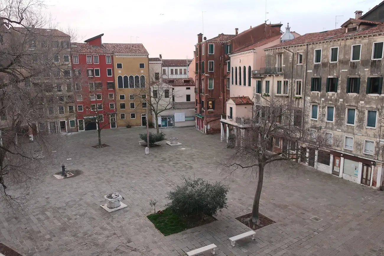 The Campo del Ghetto Nuovo square ringed by tall buildings in the Jewish Ghetto of Venice