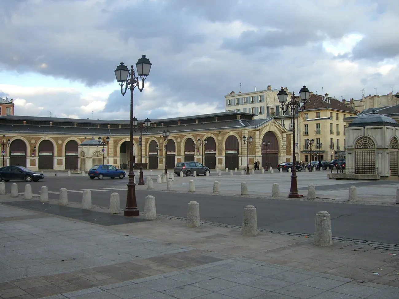 The covered halls of the Marche Notre-Dame in Versailles seen across the empty square