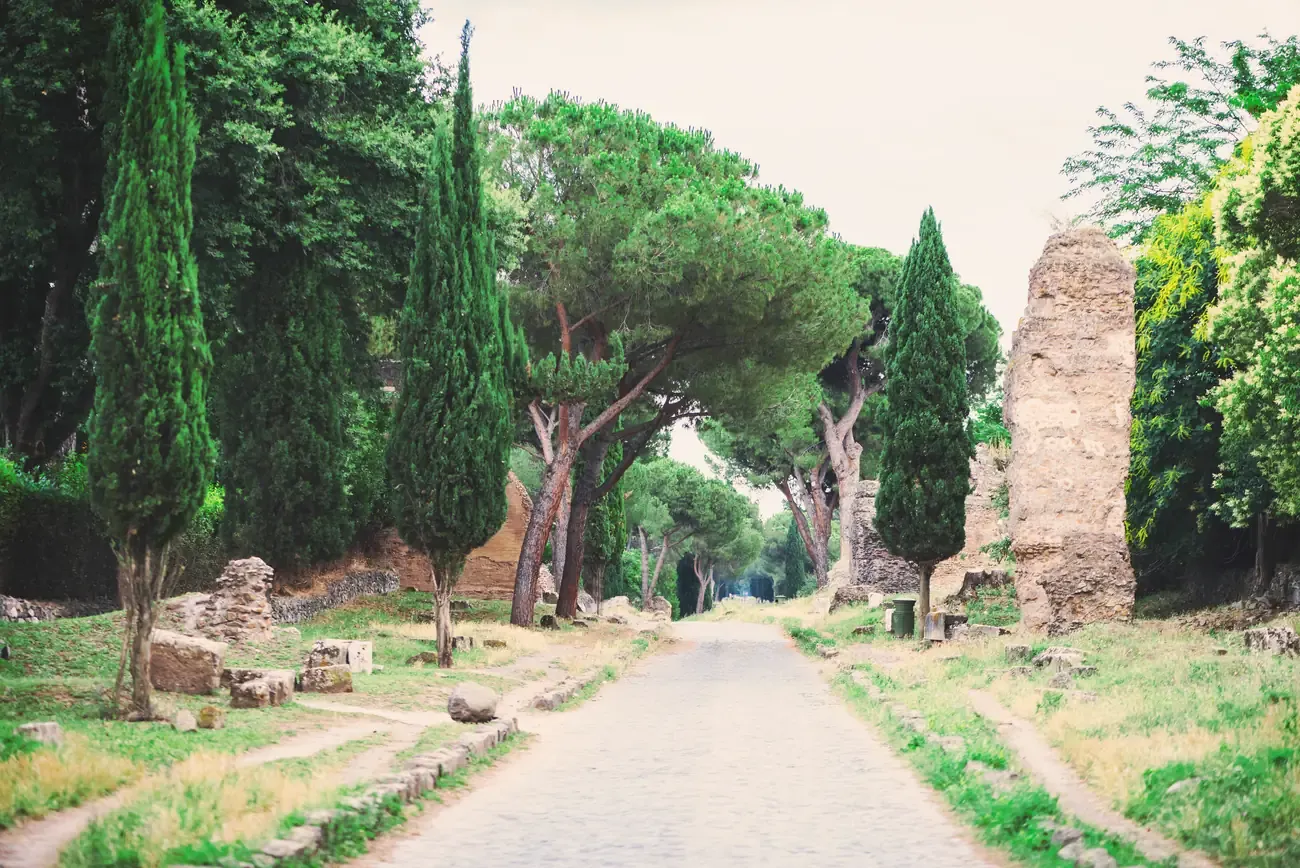 The cobbled Appian Way lined with cypresses in Rome