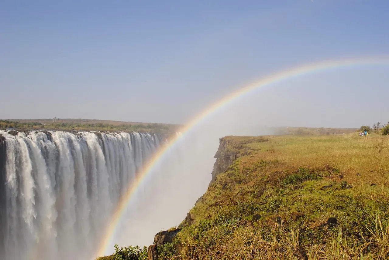 Victoria Falls with a rainbow in the spray, seen from the Zimbabwe side of the Zambezi