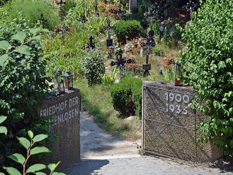 The entrance gate and rows of iron crosses at the Cemetery of the Nameless in Vienna, where unidentified bodies pulled from the Danube are buried