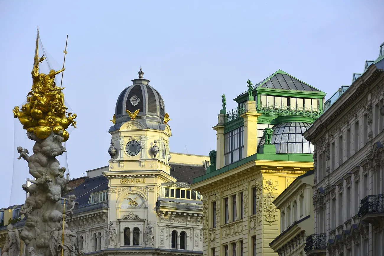 The gilded cloud and angel crown of the Vienna Plague Column rising above the rooftops of the Graben
