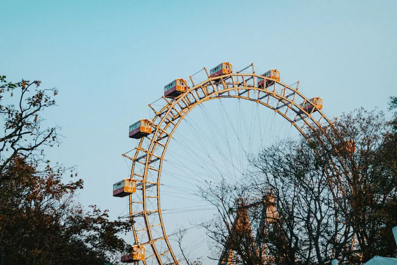 The Wiener Riesenrad Ferris wheel seen through autumn trees at the Prater in Vienna