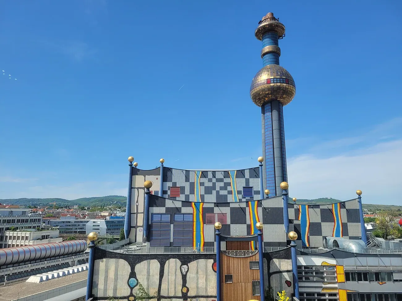 The Hundertwasser-designed Spittelau waste incineration plant with its gold mosaic chimney tower in Vienna