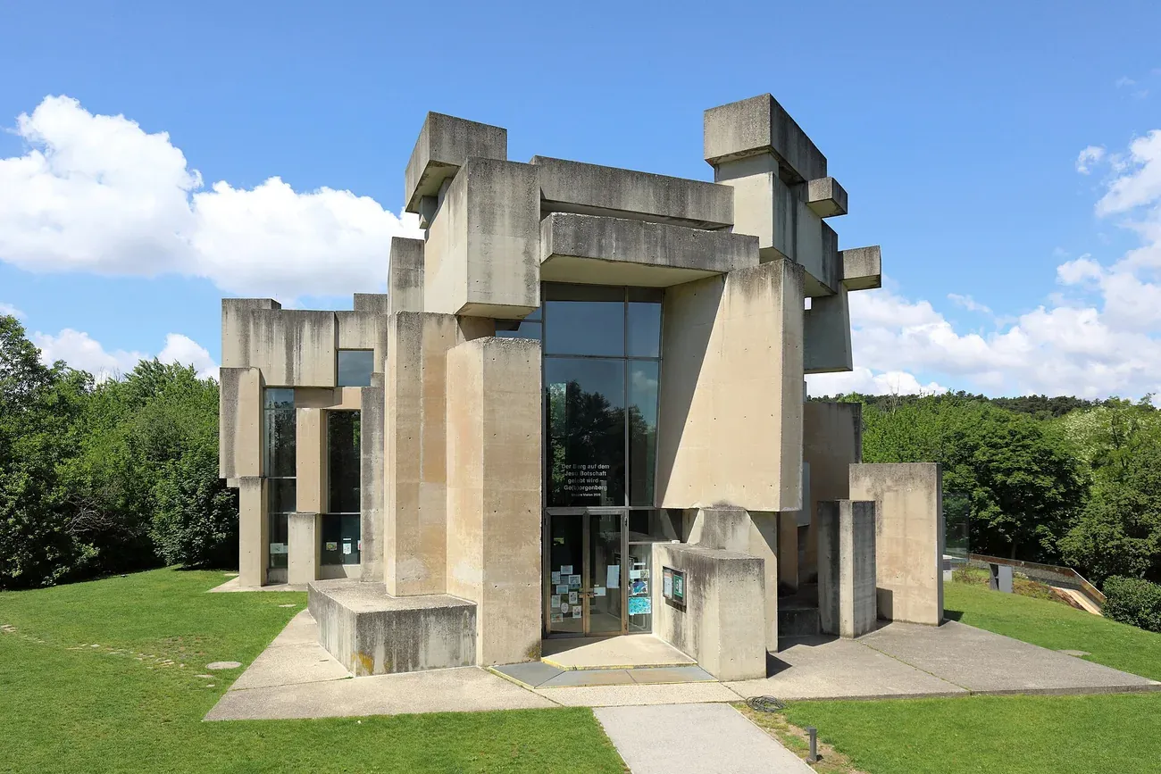 The stacked raw-concrete blocks of the brutalist Wotruba Church on its hillside in Vienna